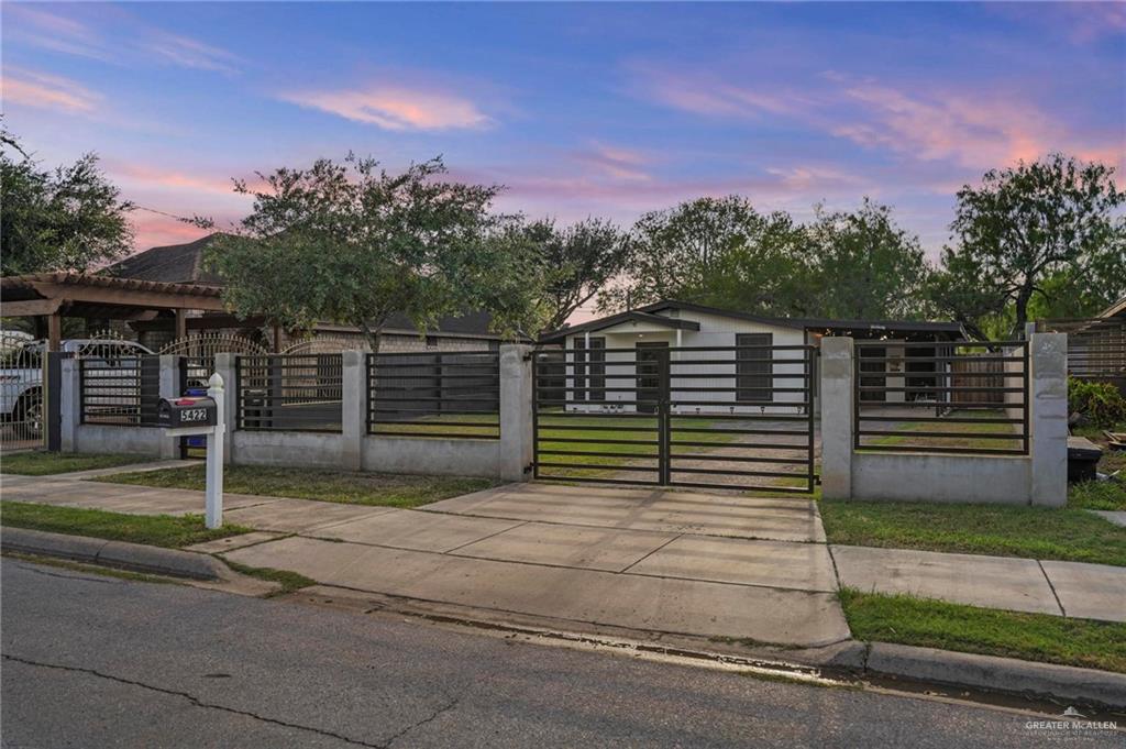 5422 South 28th Street McAllen, TX 78503 - Photo 5 of 21 Gate at dusk featuring a fenced front yard
