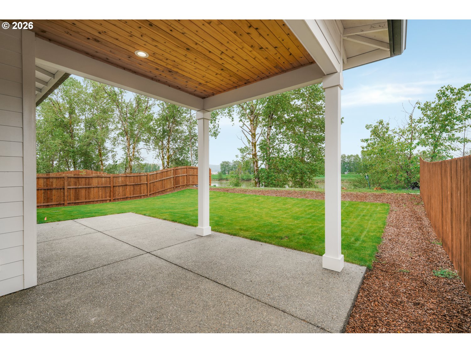 2040 South River Road Kelso, WA 98626 - Photo 32 of 43 a view of a yard with porch and wooden fence