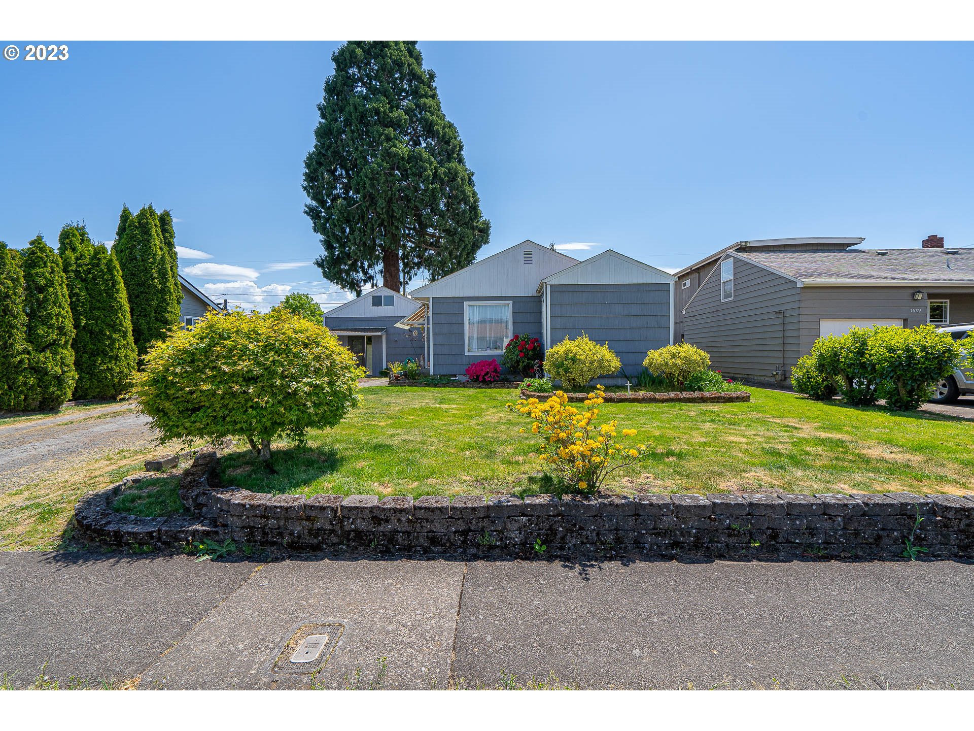 1639 F Street Springfield, OR 97477 - Photo 1 of 32 a front view of a house with a yard and potted plants