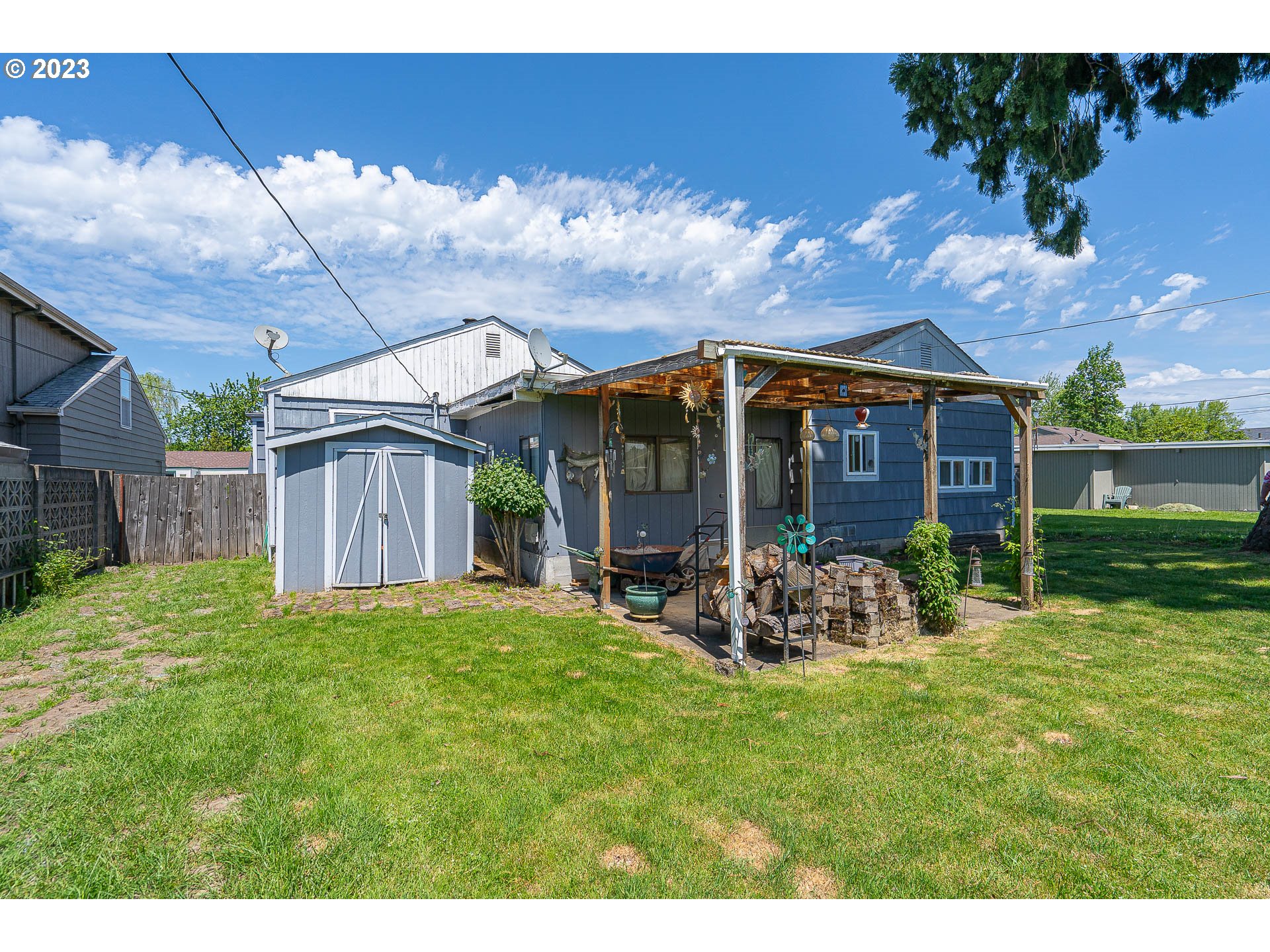 1639 F Street Springfield, OR 97477 - Photo 26 of 32 a view of a house with backyard sitting area and garden
