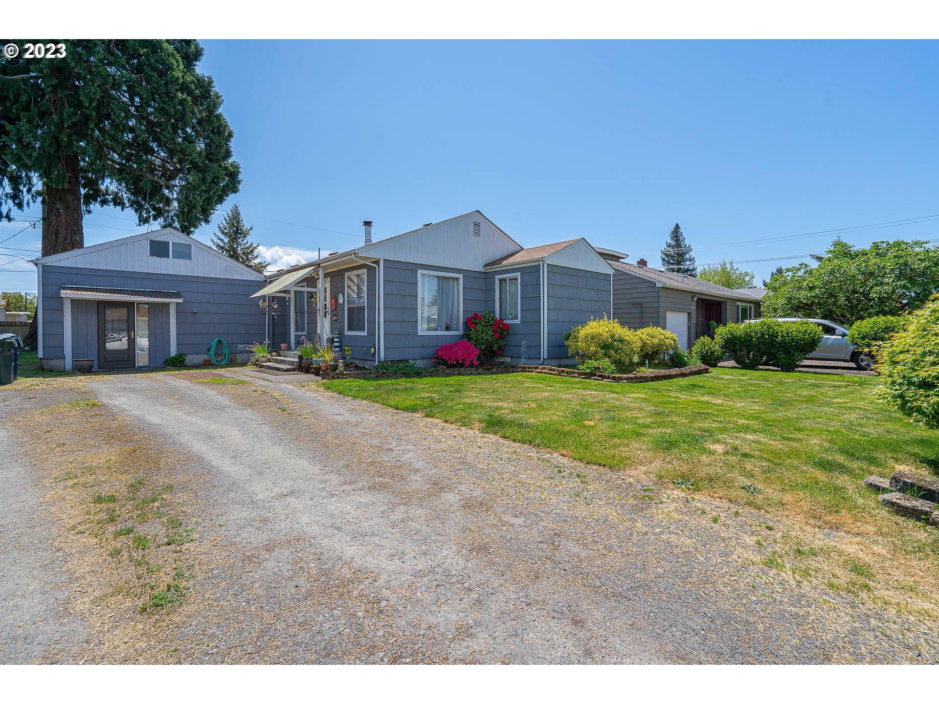 1639 F Street Springfield, OR 97477 - Photo 3 of 32 a front view of a house with a yard and garage
