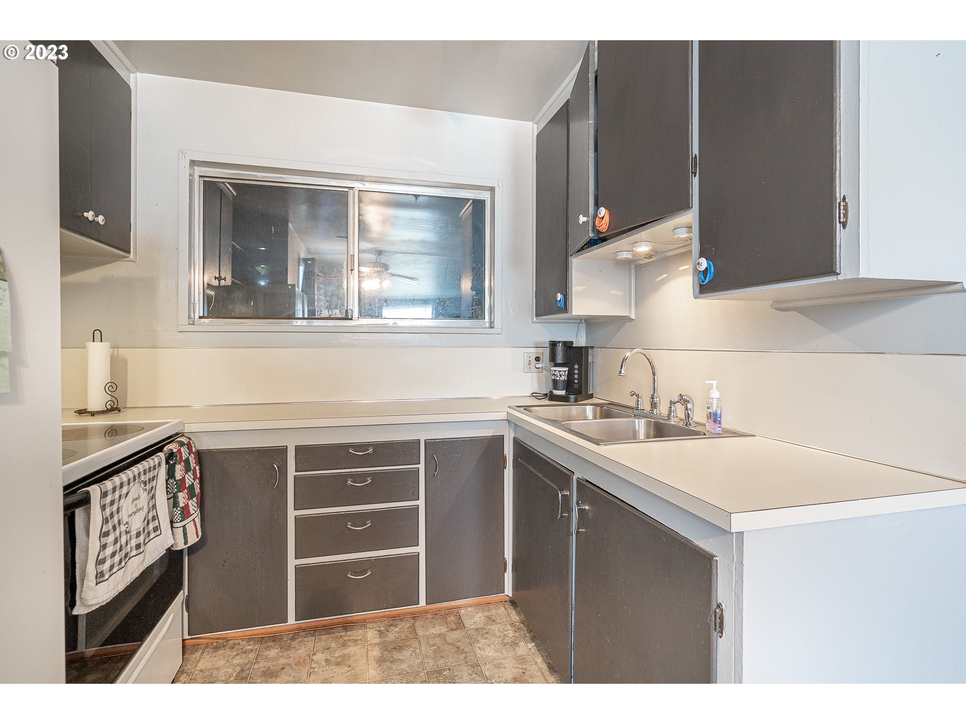 1639 F Street Springfield, OR 97477 - Photo 6 of 32 a kitchen with a sink cabinets and a window