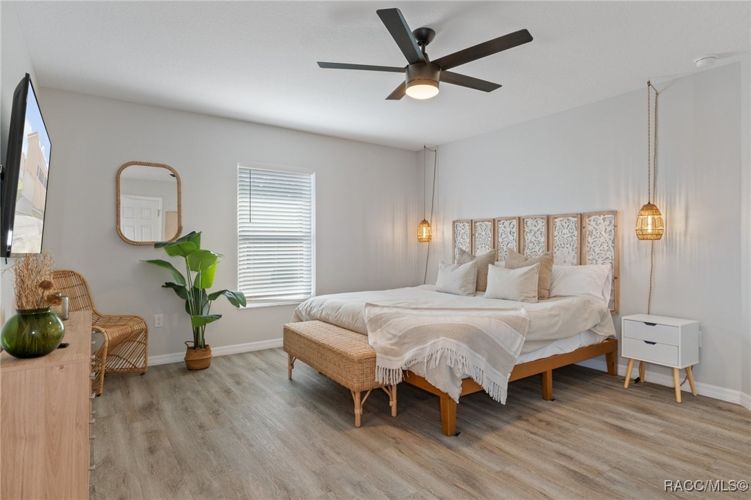 4865 South Tromp Loop Homosassa, FL 34448 - Photo 11 of 30 a bedroom with a bed and a chandelier