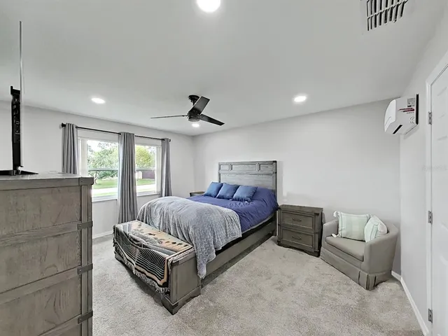 a spacious bedroom with a bed and a couch