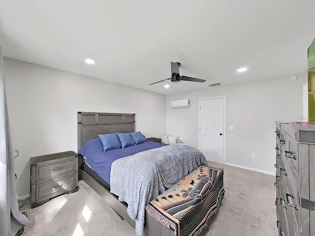 8527 Jolly Roger Drive Hudson, FL 34667 - Photo 12 of 39 a bedroom with a bed and a chandelier