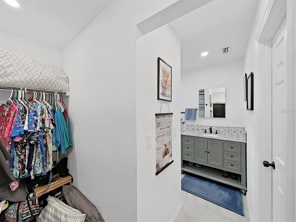 8527 Jolly Roger Drive Hudson, FL 34667 - Photo 14 of 39 a bathroom with a double vanity sink toilet and mirror