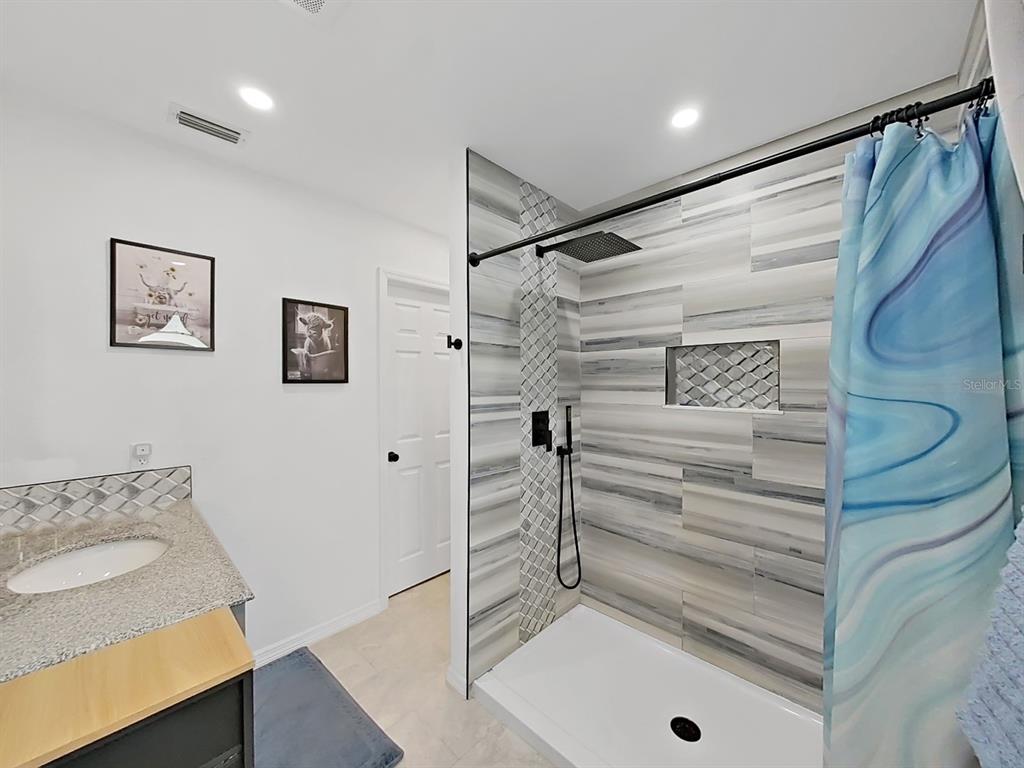 8527 Jolly Roger Drive Hudson, FL 34667 - Photo 16 of 39 a bathroom with a sink and a shower