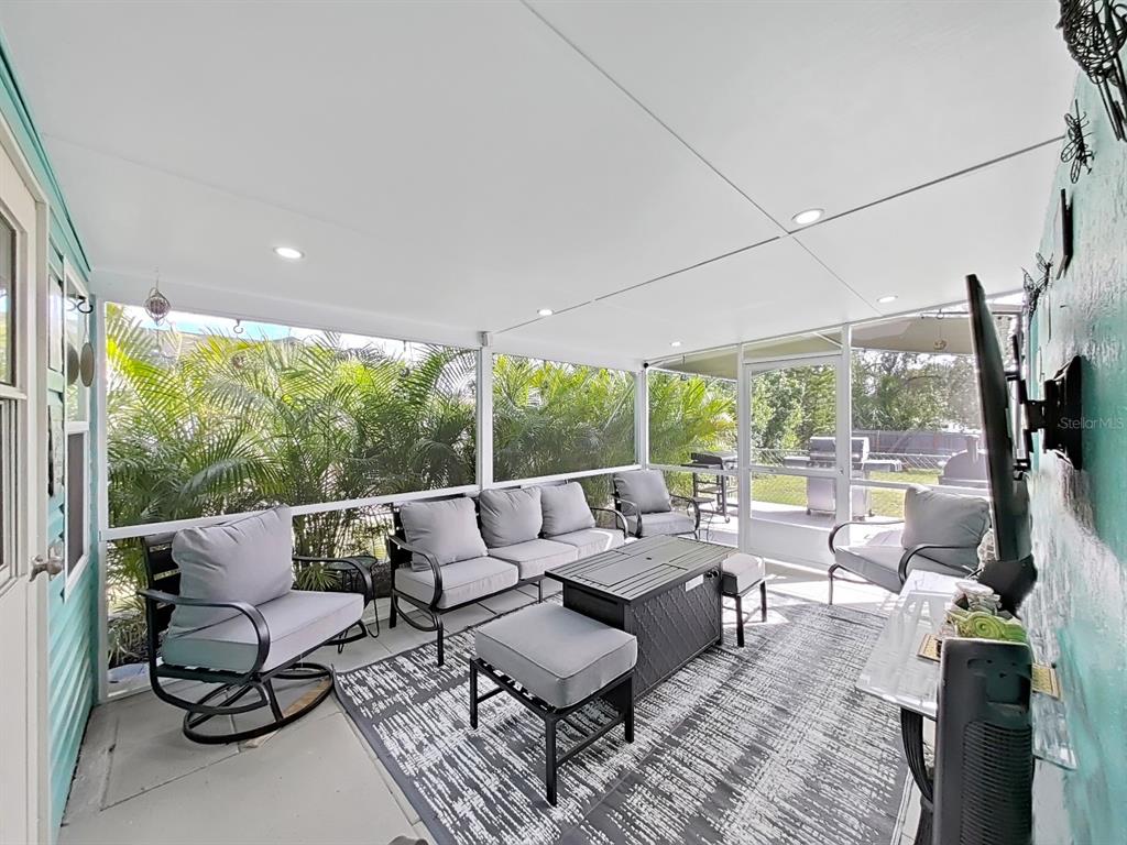 8527 Jolly Roger Drive Hudson, FL 34667 - Photo 18 of 39 a living room with furniture and a floor to ceiling window