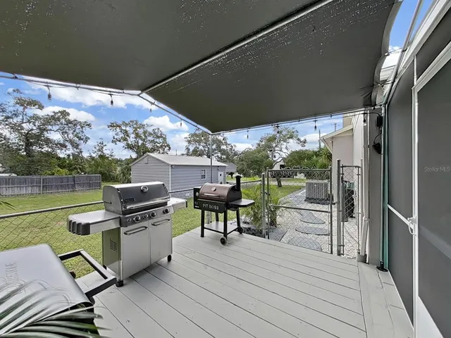 a view of a chairs and table on the wooden deck