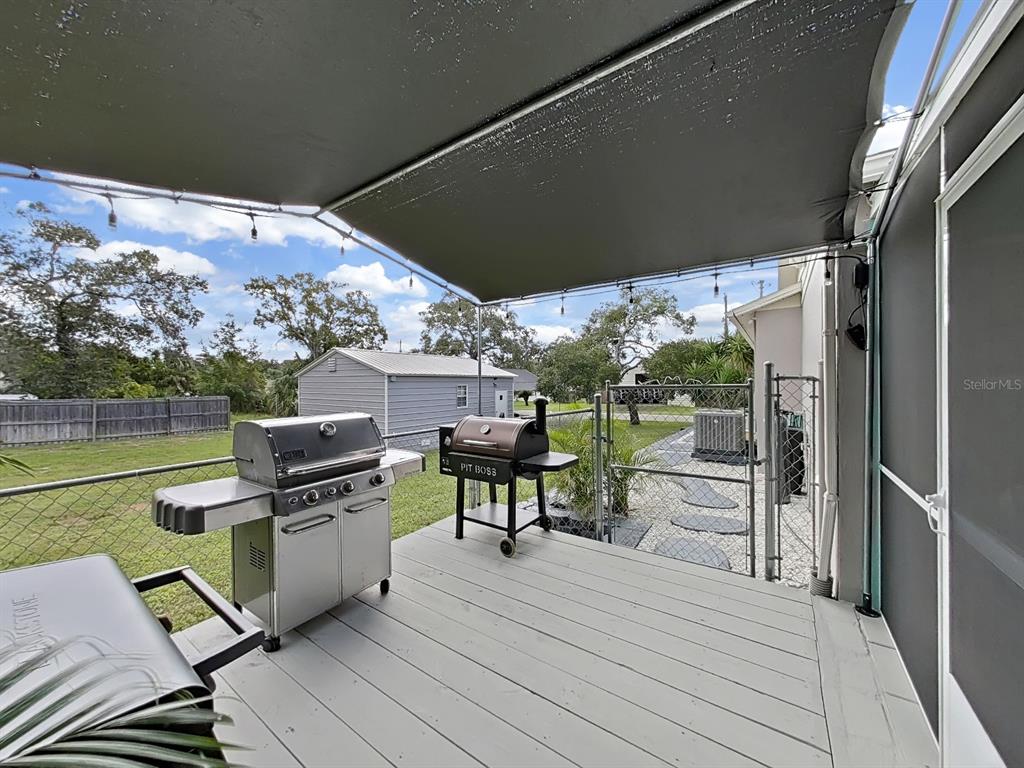 8527 Jolly Roger Drive Hudson, FL 34667 - Photo 20 of 39 a view of a chairs and table on the wooden deck