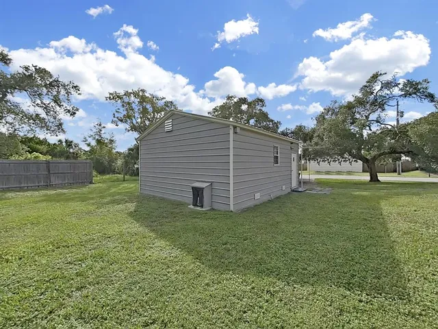 a view of a backyard with large trees