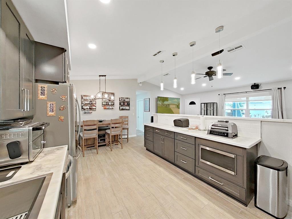 8527 Jolly Roger Drive Hudson, FL 34667 - Photo 3 of 39 a kitchen that has a lot of cabinets in it and appliances