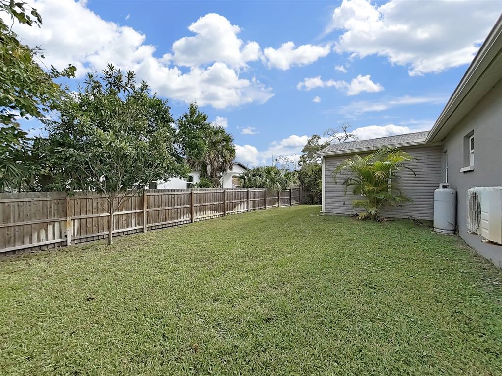 8527 Jolly Roger Drive Hudson, FL 34667 - Photo 34 of 39 a backyard of a house with lots of green space