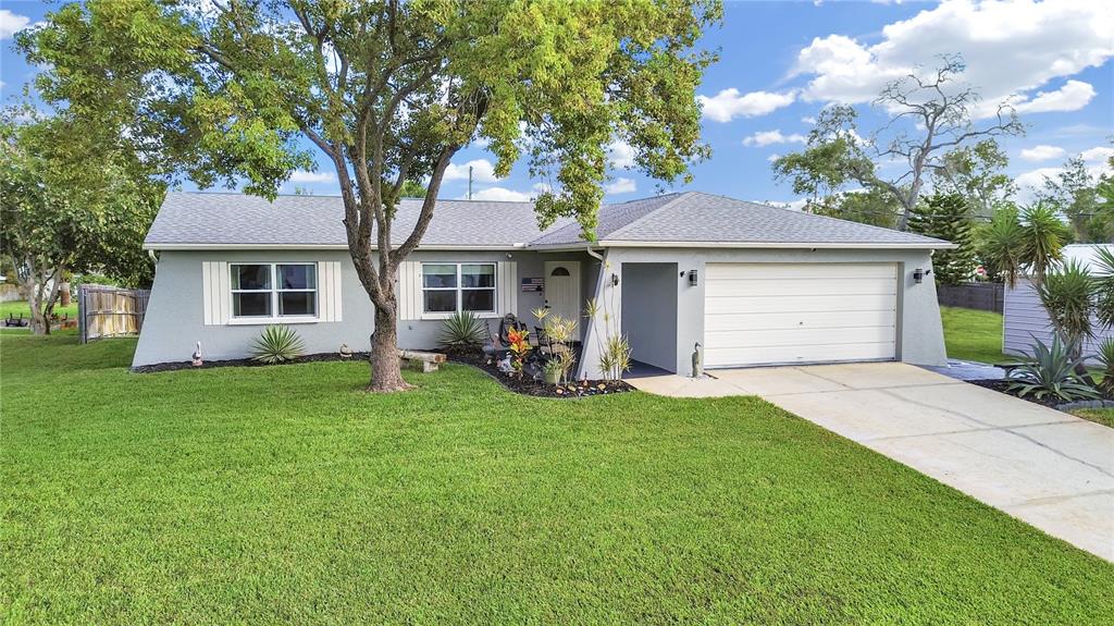 8527 Jolly Roger Drive Hudson, FL 34667 - Photo 37 of 39 a view of a house with a yard