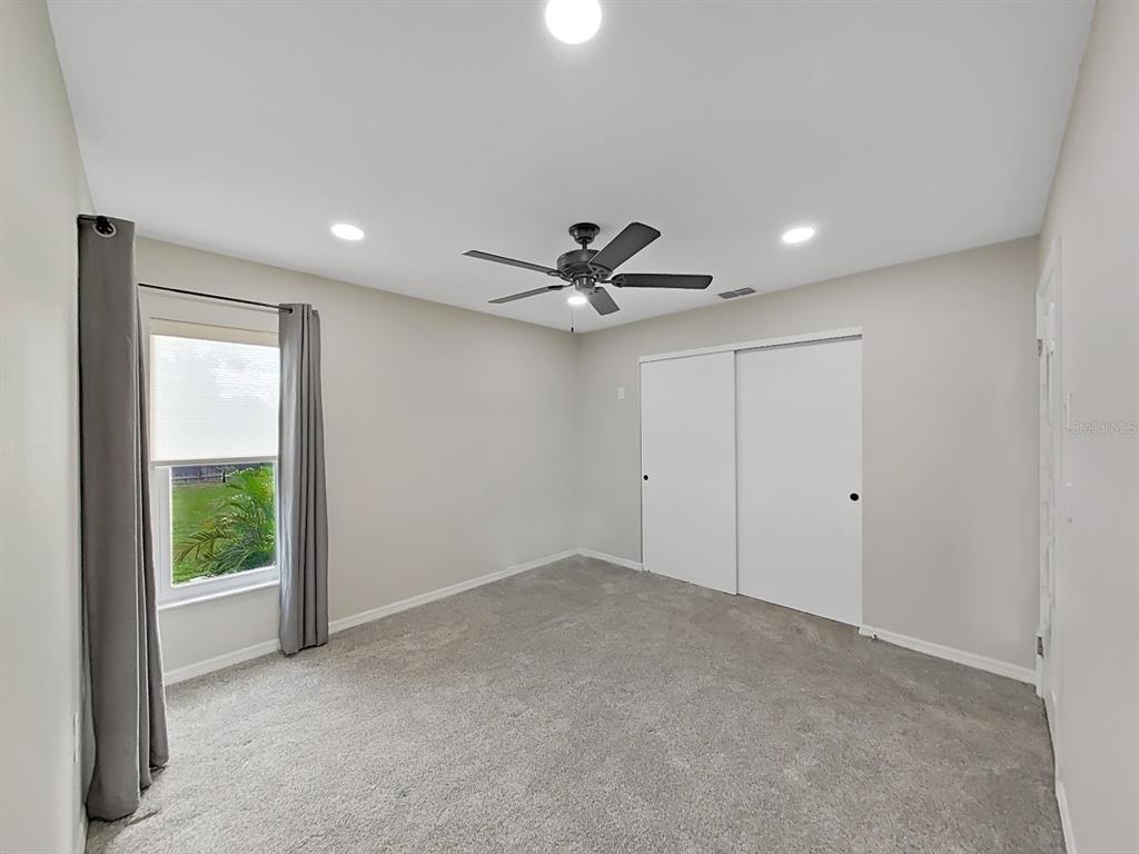 8527 Jolly Roger Drive Hudson, FL 34667 - Photo 8 of 39 a view of a livingroom with a ceiling fan and window