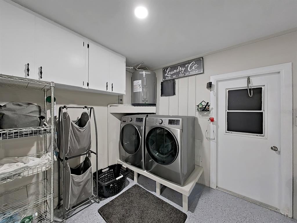 8527 Jolly Roger Drive Hudson, FL 34667 - Photo 10 of 39 a utility room with dryer and washer