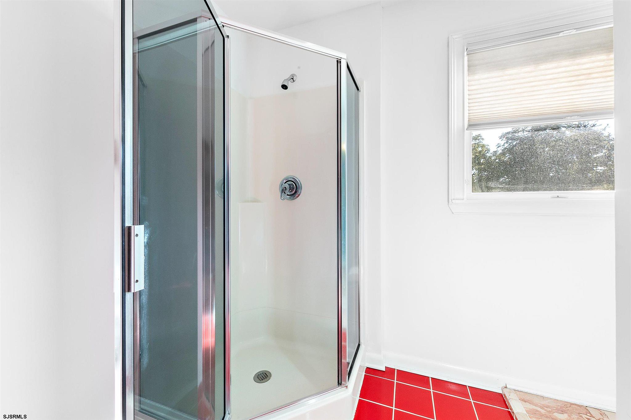 1401 Shore Road Northfield, NJ 08225 - Photo 48 of 96 a bathroom with a shower and a glass door