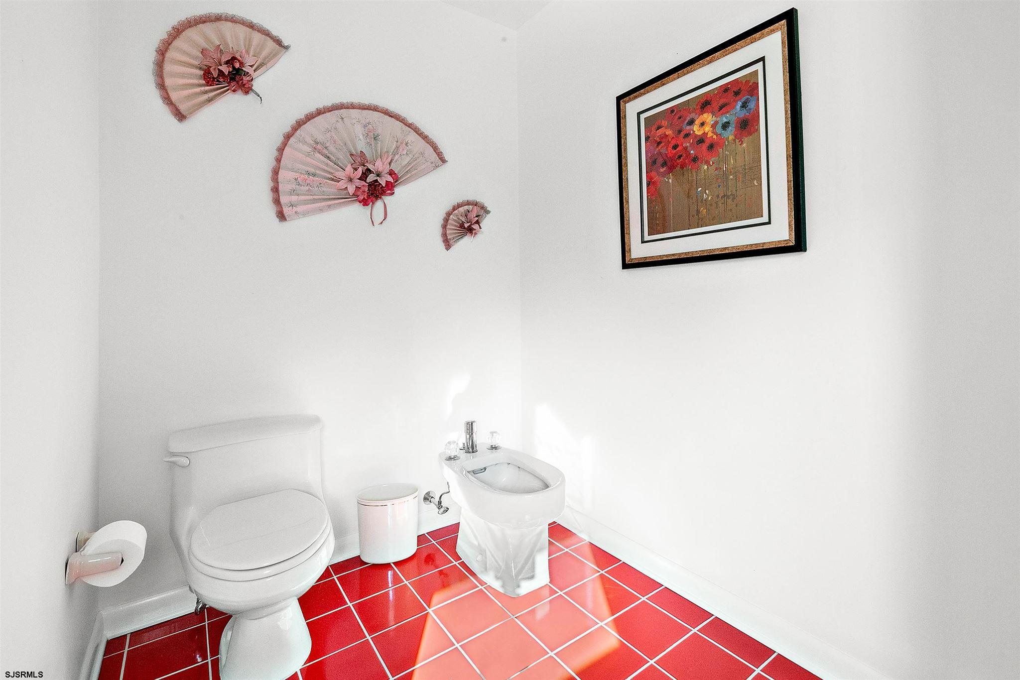 1401 Shore Road Northfield, NJ 08225 - Photo 49 of 96 a bathroom with a mirror and a picture on the wall