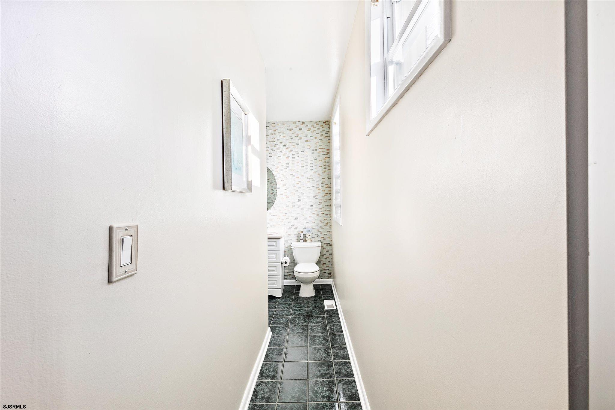1401 Shore Road Northfield, NJ 08225 - Photo 65 of 96 a view of a hallway with wooden floor and a bathroom