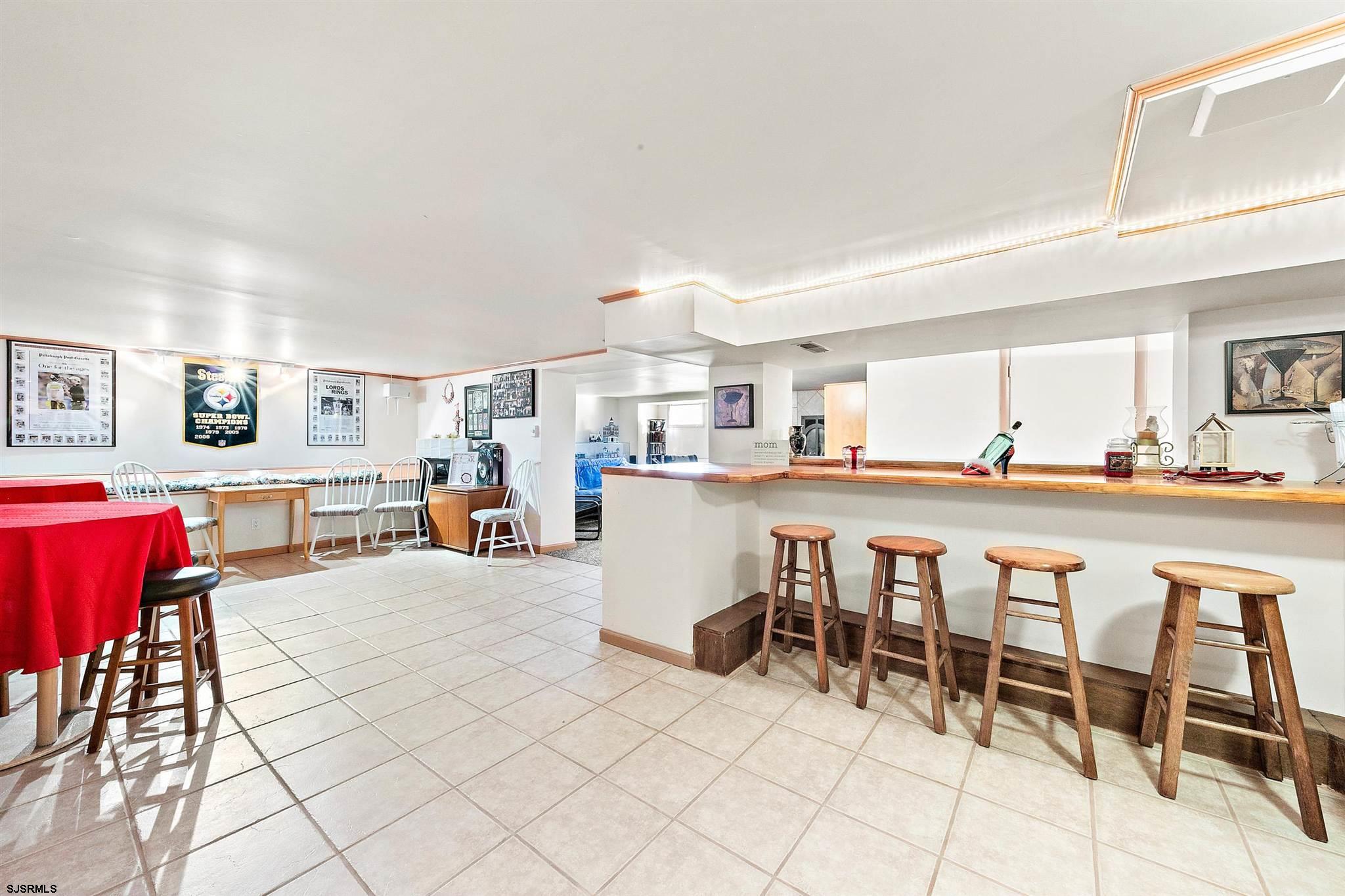 1401 Shore Road Northfield, NJ 08225 - Photo 74 of 96 a open kitchen with stainless steel appliances kitchen island granite countertop a table and chairs in it