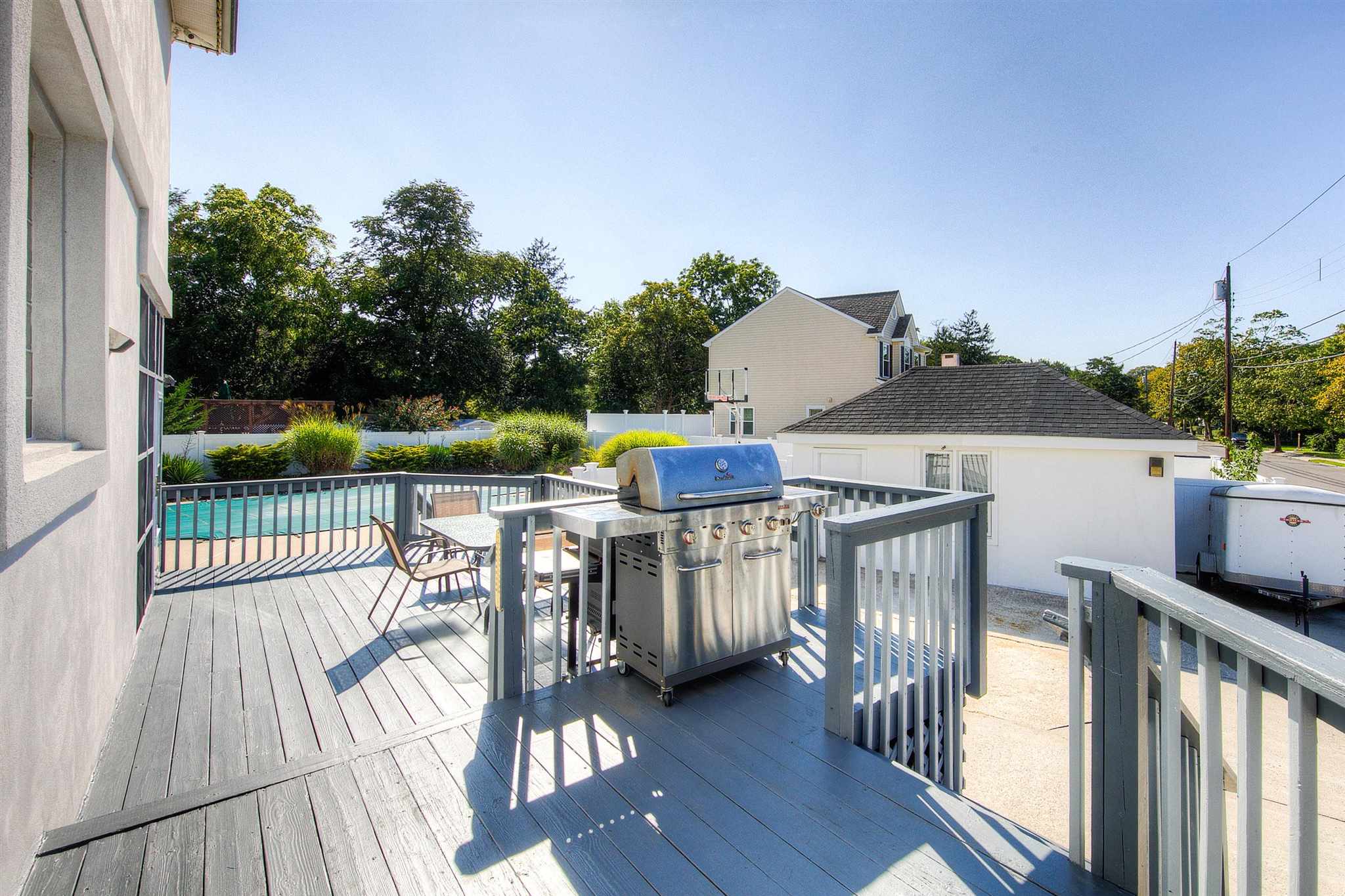 1401 Shore Road Northfield, NJ 08225 - Photo 75 of 96 a view of a balcony with wooden floor and outdoor seating