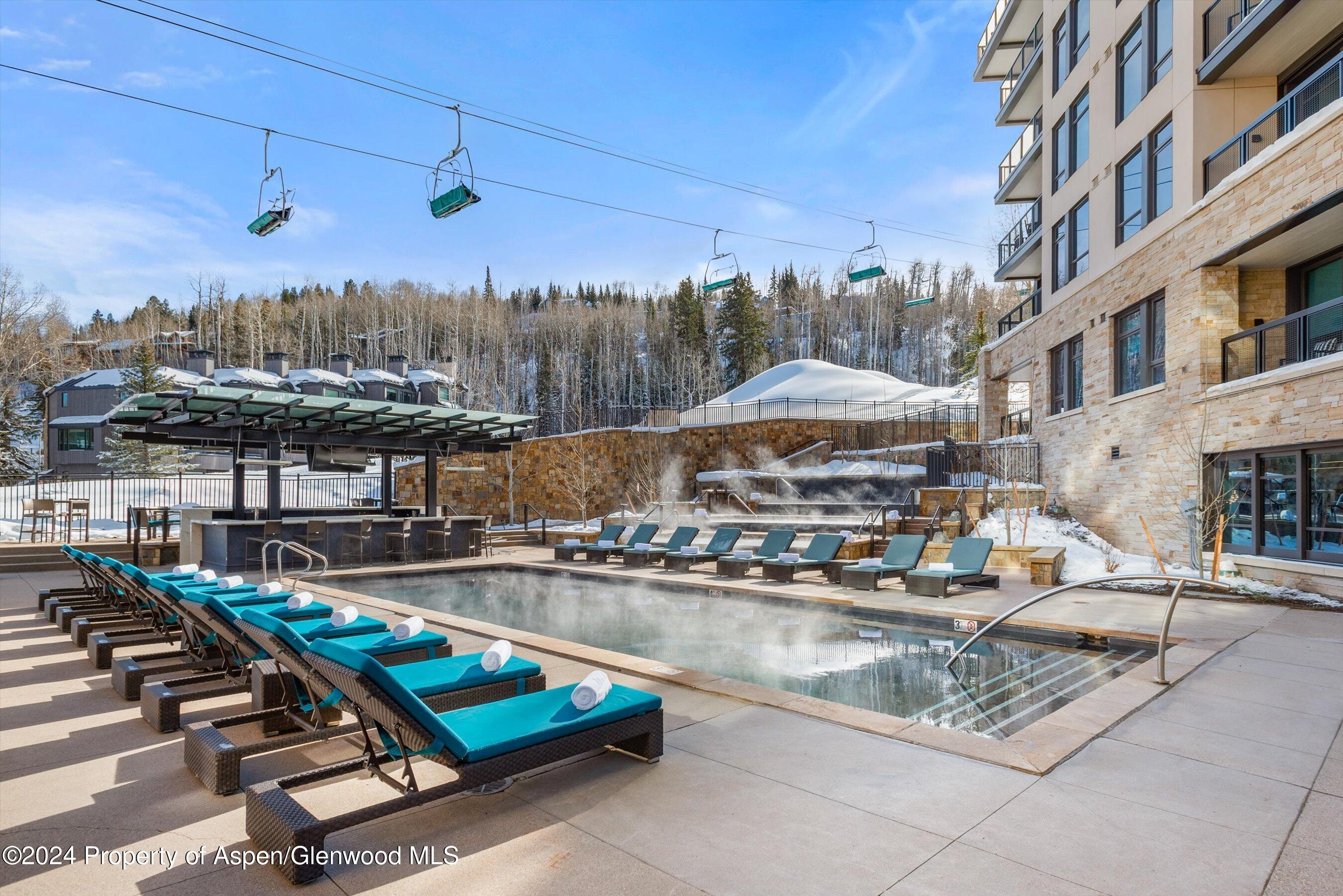130 Wood Road, Unit 504 Snowmass Village, CO 81615 - Photo 13 of 20 a view of a swimming pool with sitting area