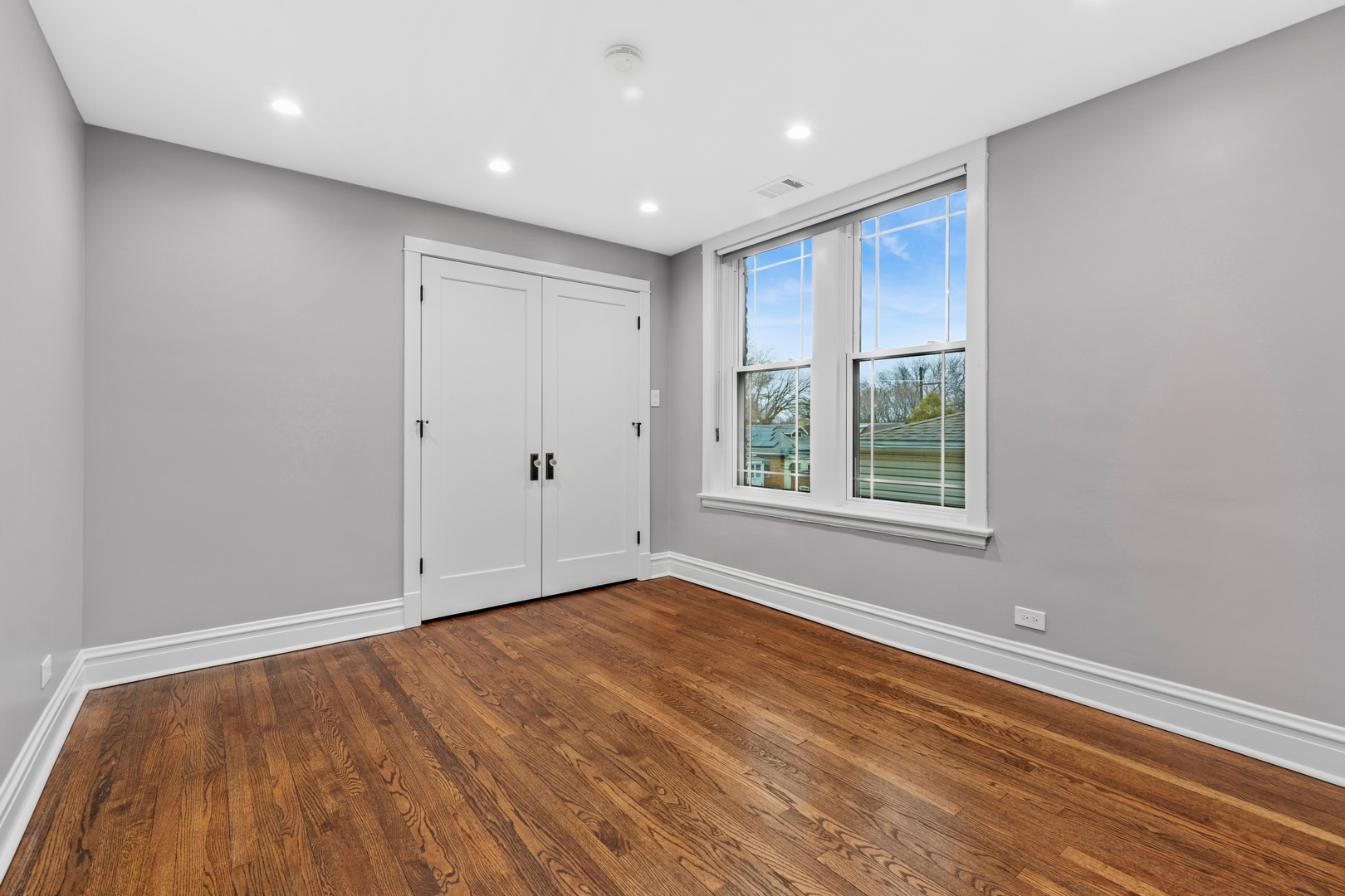 4932 North Ridgeway Avenue, Unit 2 Chicago, IL 60625 - Photo 12 of 21 a view of an empty room with wooden floor and a window