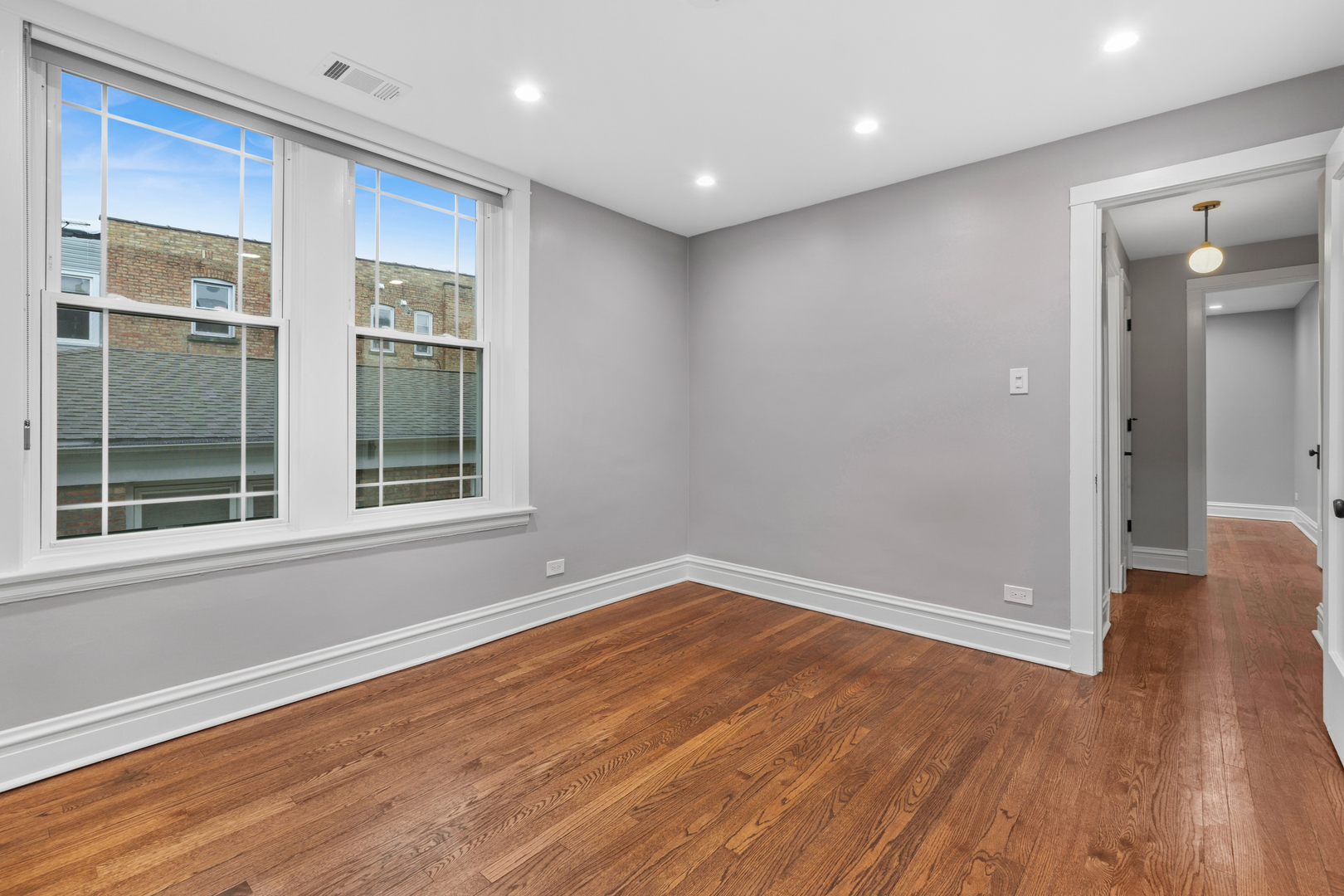 4932 North Ridgeway Avenue, Unit 2 Chicago, IL 60625 - Photo 13 of 21 a view of empty room with wooden floor and fan