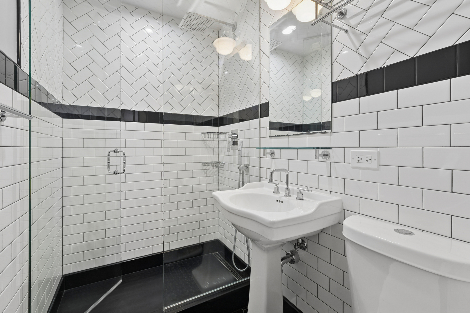 4932 North Ridgeway Avenue, Unit 2 Chicago, IL 60625 - Photo 16 of 21 a bathroom with a sink a mirror and shower