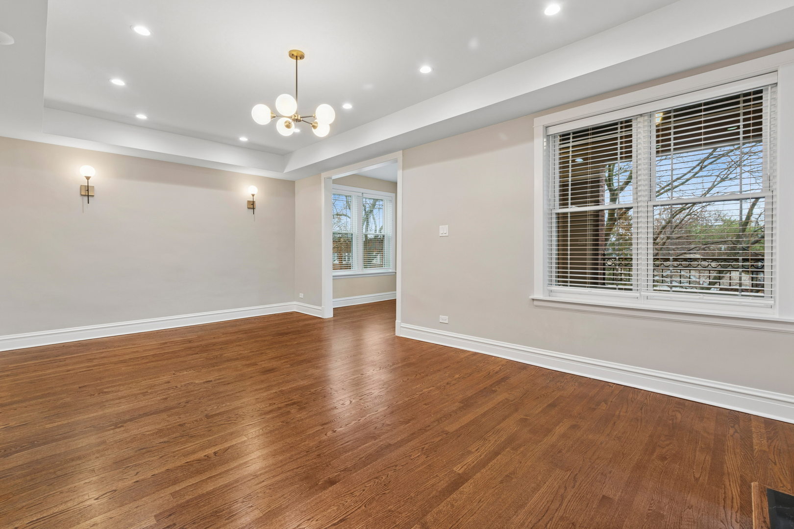 4932 North Ridgeway Avenue, Unit 2 Chicago, IL 60625 - Photo 4 of 21 a view of an empty room with wooden floor and a window
