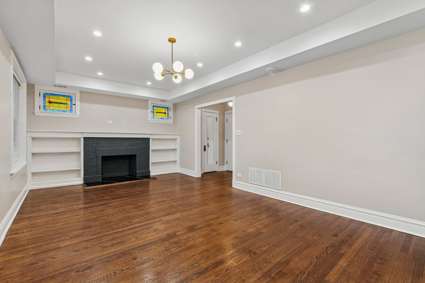 4932 North Ridgeway Avenue, Unit 2 Chicago, IL 60625 - Photo 6 of 21 an empty room with wooden floor fireplace and window