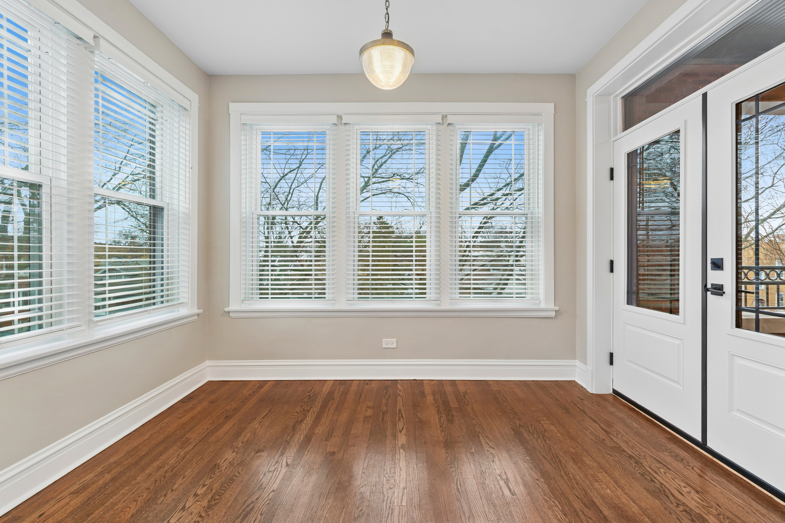4932 North Ridgeway Avenue, Unit 2 Chicago, IL 60625 - Photo 7 of 21 a view of an empty room with wooden floor and a window