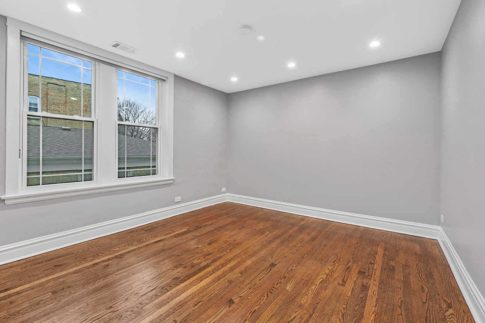 4932 North Ridgeway Avenue, Unit 2 Chicago, IL 60625 - Photo 9 of 21 a view of empty room with wooden floor and fan