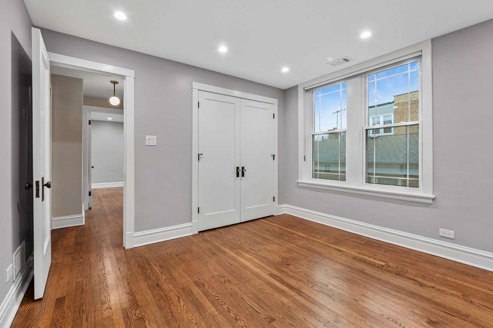 4932 North Ridgeway Avenue, Unit 2 Chicago, IL 60625 - Photo 10 of 21 a view of an empty room with wooden floor and a window
