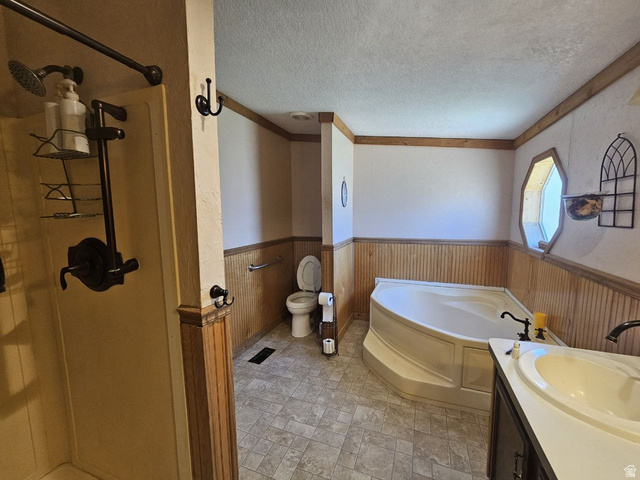 52 Quail Court Moab, UT 84532 - Photo 24 of 36 Bathroom featuring a corner soaking tub, a hexagonal window, and beadboard paneling