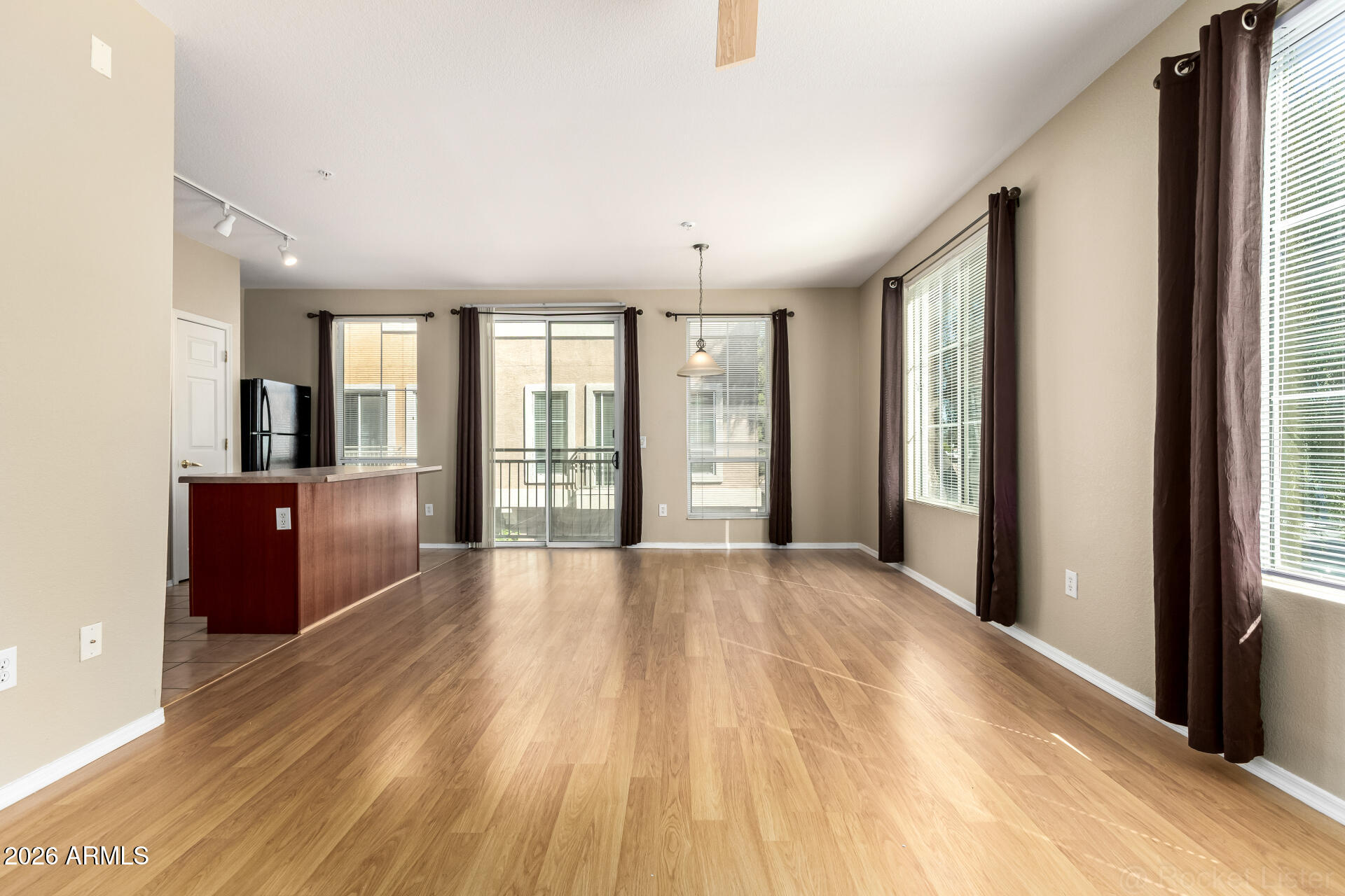 a view of an empty room with large windows