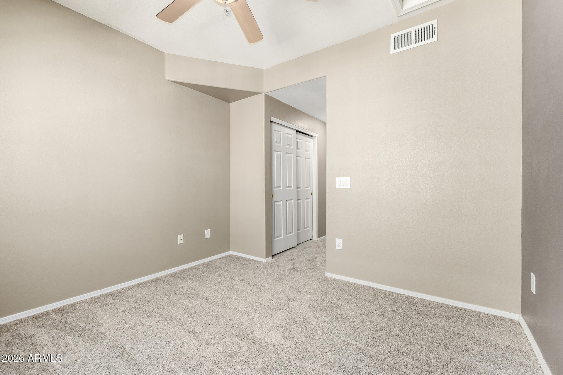 18250 North Cave Creek Road, Unit 198 Phoenix, AZ 85032 - Photo 16 of 30 an empty room with closet and chandelier fan