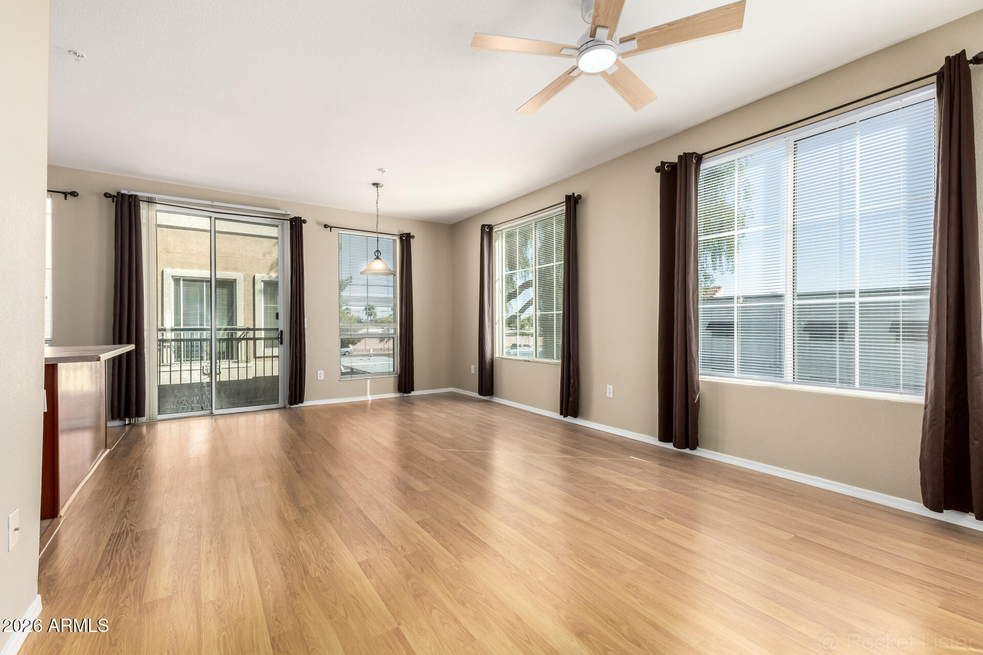18250 North Cave Creek Road, Unit 198 Phoenix, AZ 85032 - Photo 2 of 30 a view of an empty room with a window and wooden floor
