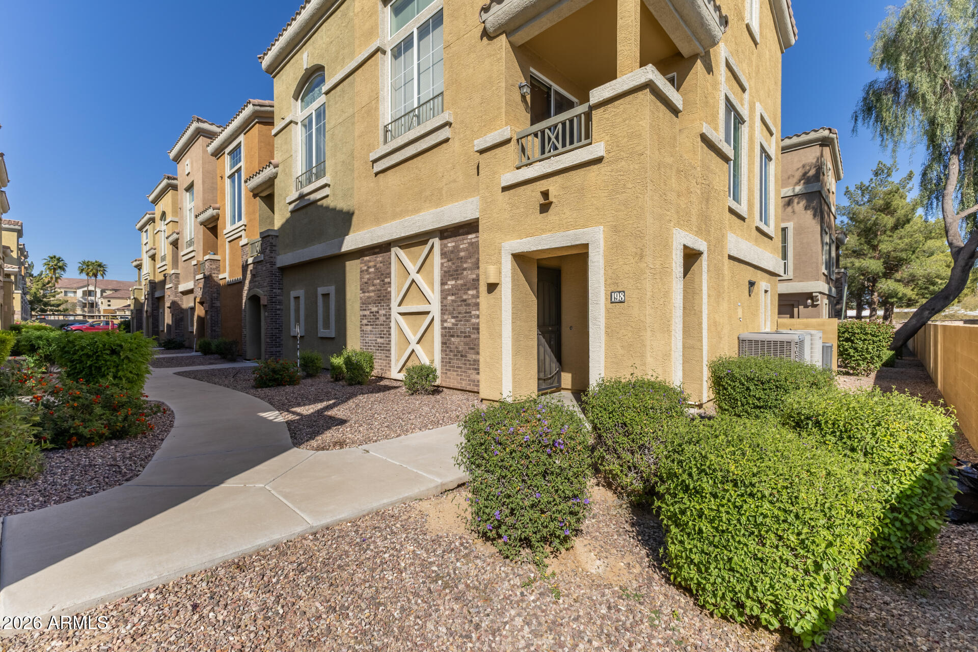 18250 North Cave Creek Road, Unit 198 Phoenix, AZ 85032 - Photo 21 of 30 a view of a building with a yard
