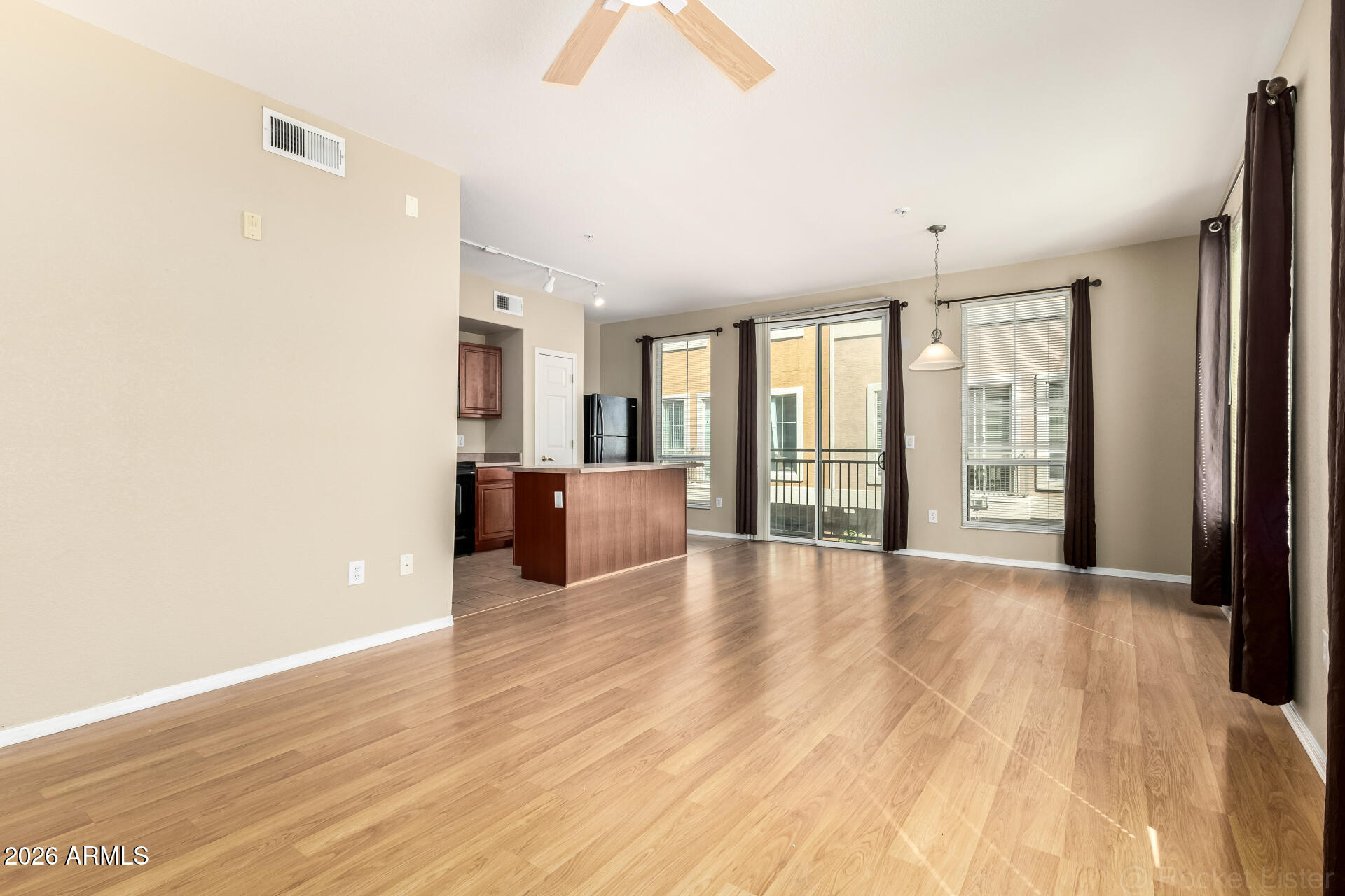 18250 North Cave Creek Road, Unit 198 Phoenix, AZ 85032 - Photo 3 of 30 a view of an empty room with a window and wooden floor