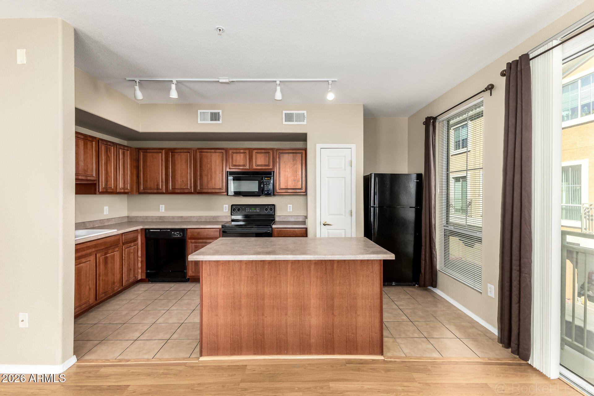 18250 North Cave Creek Road, Unit 198 Phoenix, AZ 85032 - Photo 6 of 30 a large kitchen with stainless steel appliances kitchen island granite countertop a refrigerator and a stove top oven
