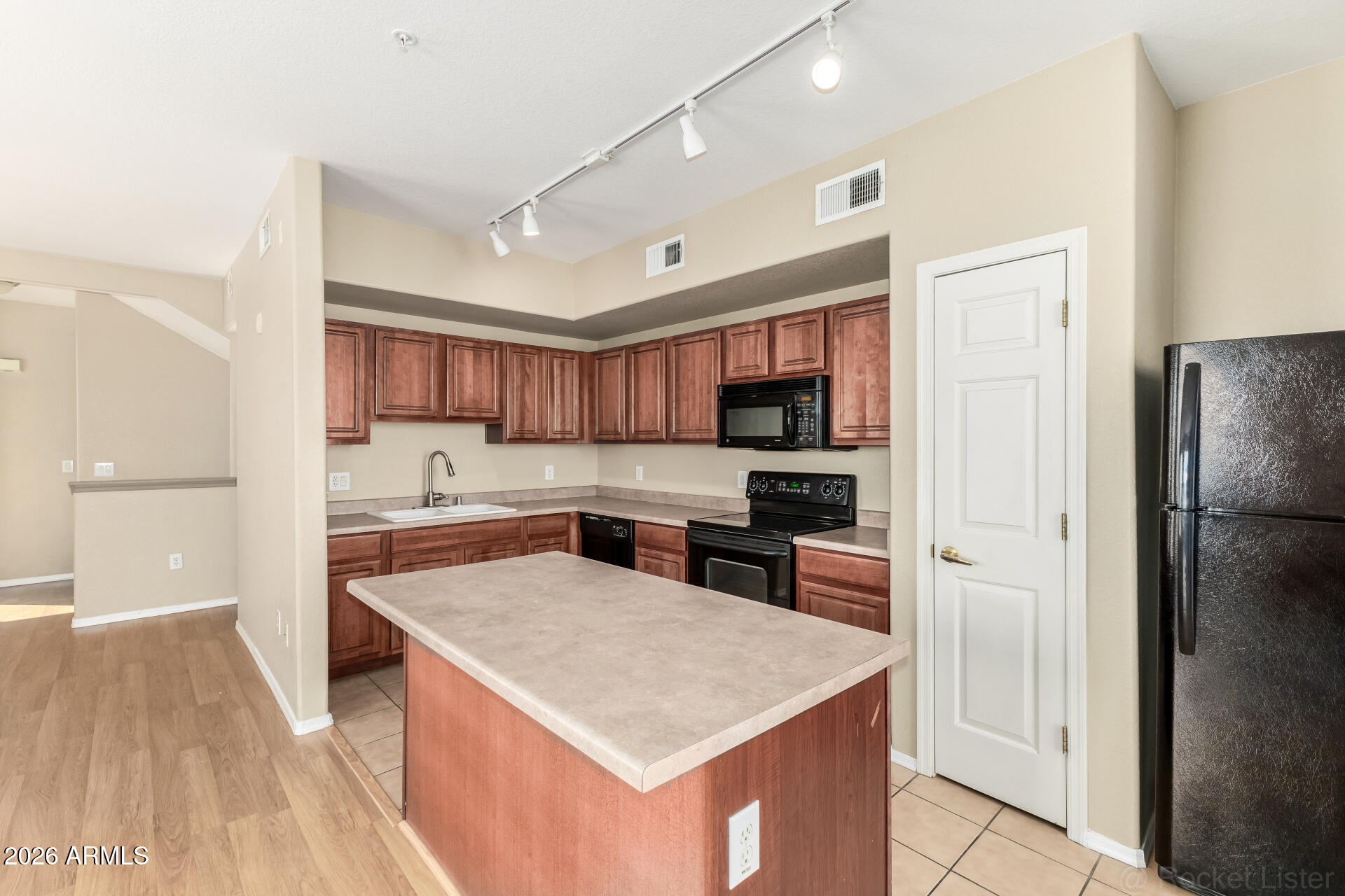 18250 North Cave Creek Road, Unit 198 Phoenix, AZ 85032 - Photo 7 of 30 a kitchen with cabinets and stainless steel appliances