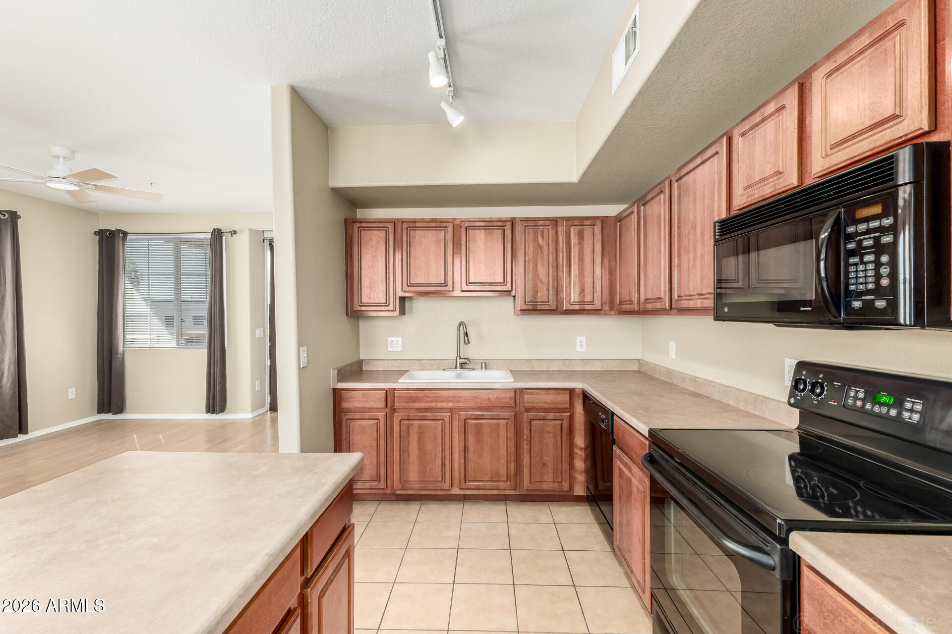 18250 North Cave Creek Road, Unit 198 Phoenix, AZ 85032 - Photo 8 of 30 a kitchen with a sink a stove cabinets and wooden floor