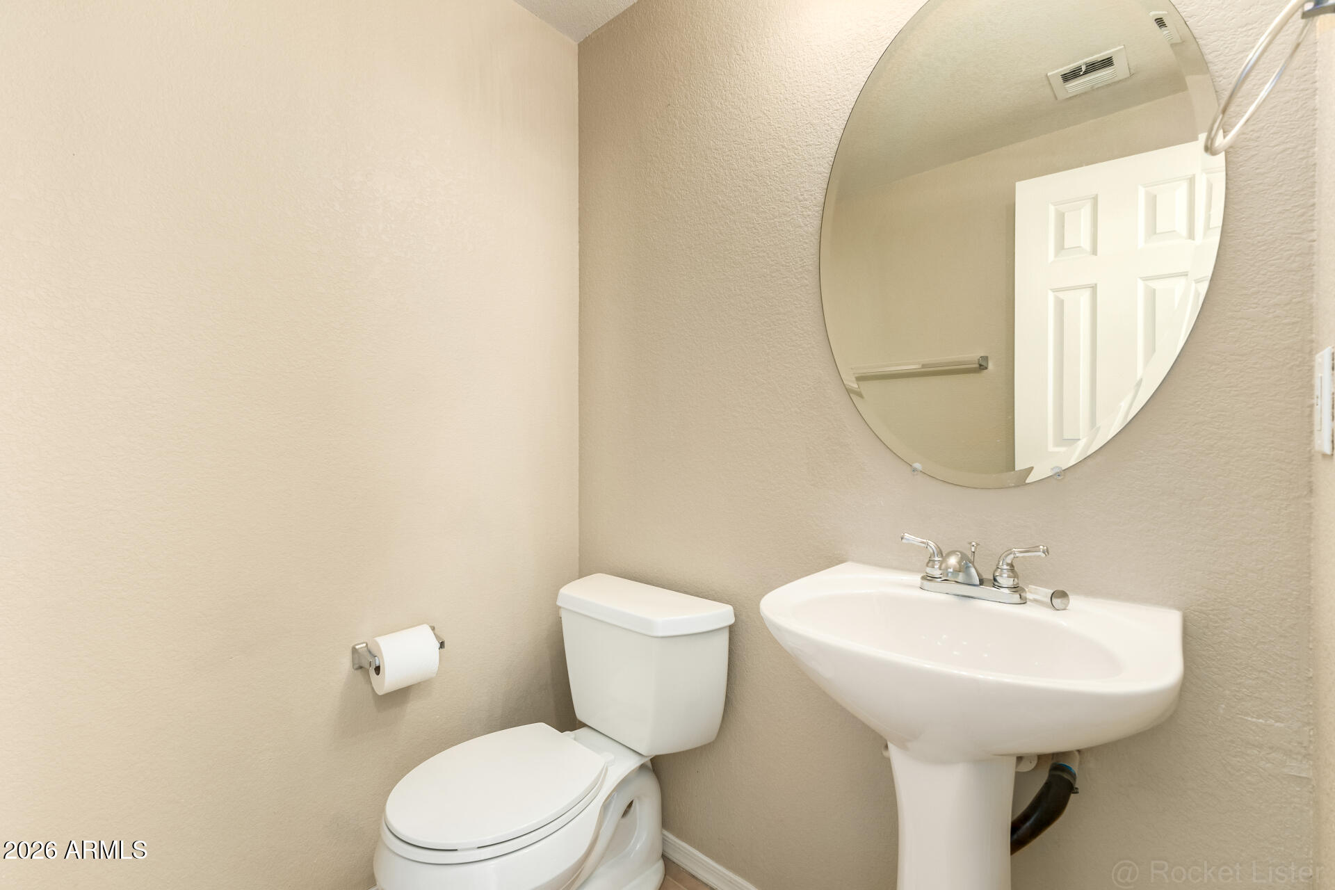 18250 North Cave Creek Road, Unit 198 Phoenix, AZ 85032 - Photo 9 of 30 a bathroom with a toilet a sink and a mirror