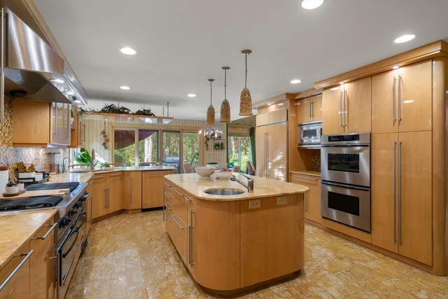 a kitchen with sink cabinets and stainless steel appliances