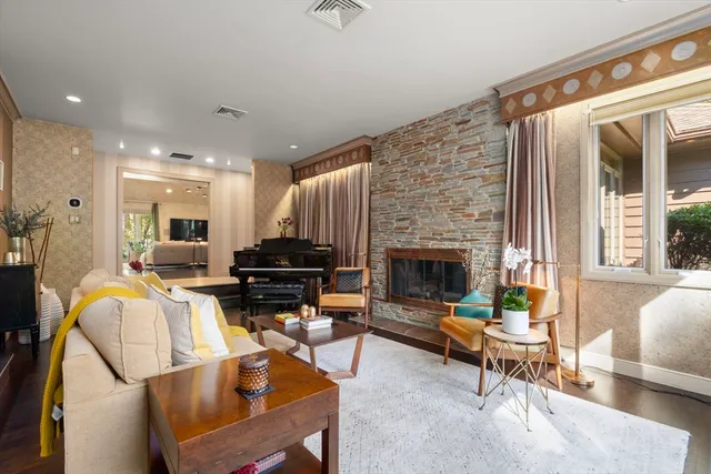 a living room with furniture a fireplace and a table