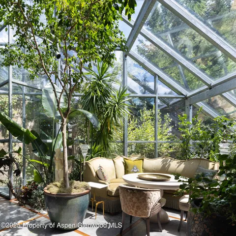 a view of a patio with table and chairs and potted plants