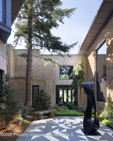 a view of a house with a tree in front of it