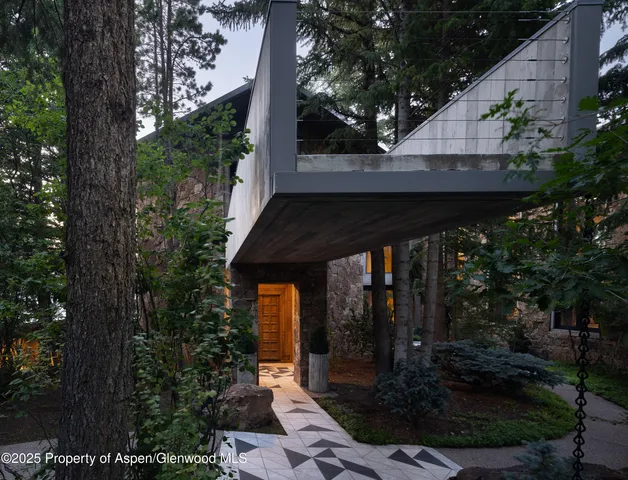 a view of a patio with table and chairs with wooden fence and plants