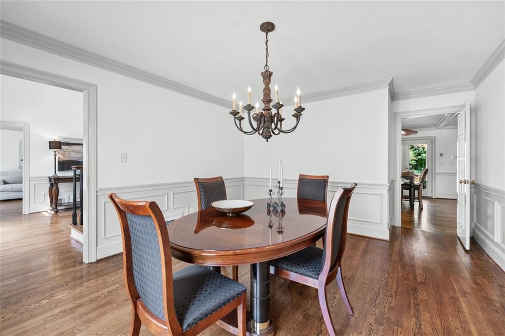 2065 Innsfail Drive Snellville, GA 30078 - Photo 11 of 71 a dining room with furniture wooden floor a rug and a chandelier